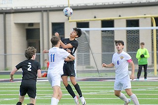 White Hall's Denilson Hernandez (12) leaps for the ball while defended by Sheridan's Caleb Harrison (11) during Friday's boys' soccer game at Bulldog Stadium. White Hall's Kaden Barnes (2) and Sheridan's Kai Herring (6) look on. (Special to the Commercial/William Harvey)